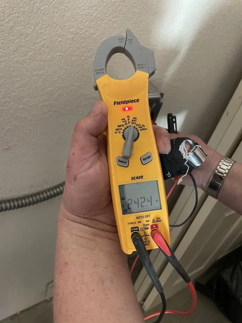 Voltage testing with clamp meter during Whole House Surge Protector in Rusk